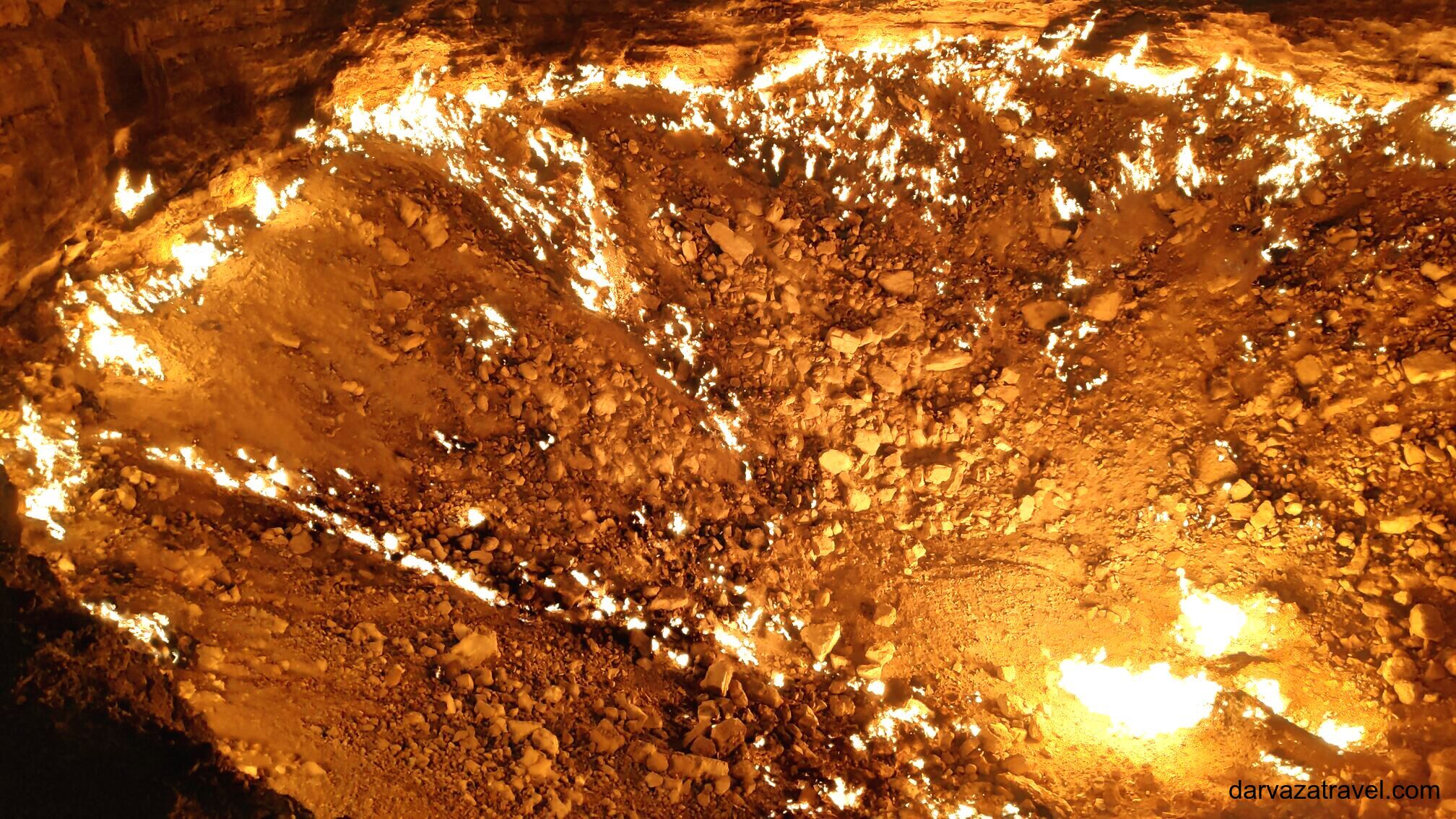 Traditional Turkmen yurt camp set against the glowing flames of the Darvaza gas crater at night during a 2-day desert tour from Khiva.